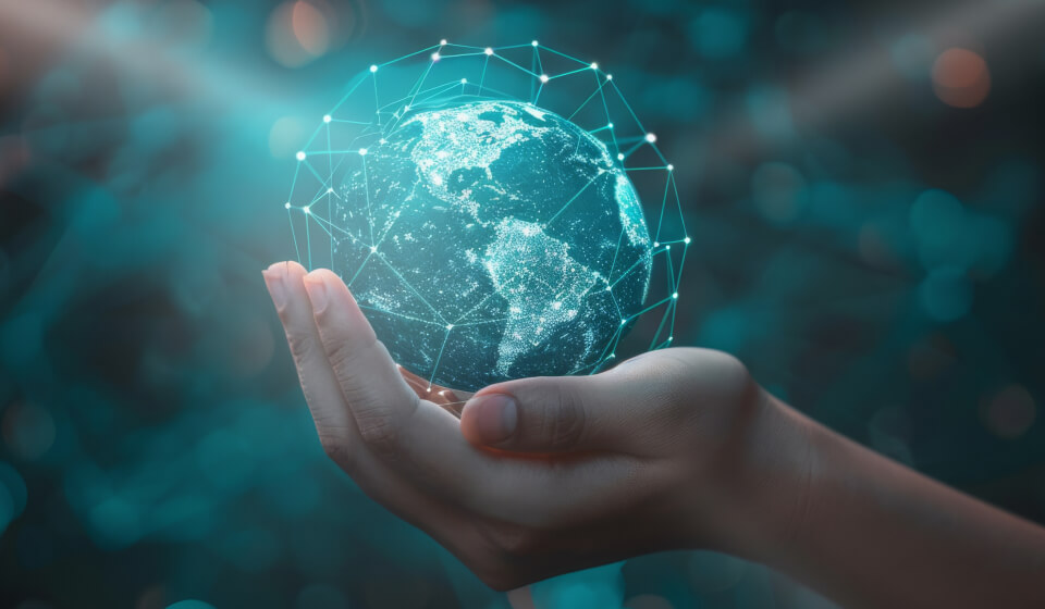 A hand is holding a holographic globe with is surrounded by blue lines connected at blue-dot vertices, representing Newshost’s extensive Usenet network.